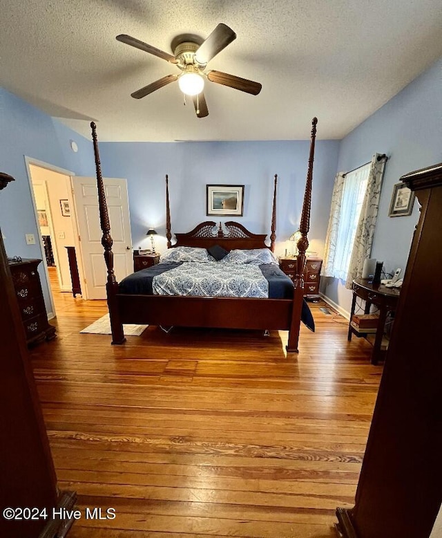 bedroom featuring ceiling fan, a textured ceiling, and light hardwood / wood-style flooring