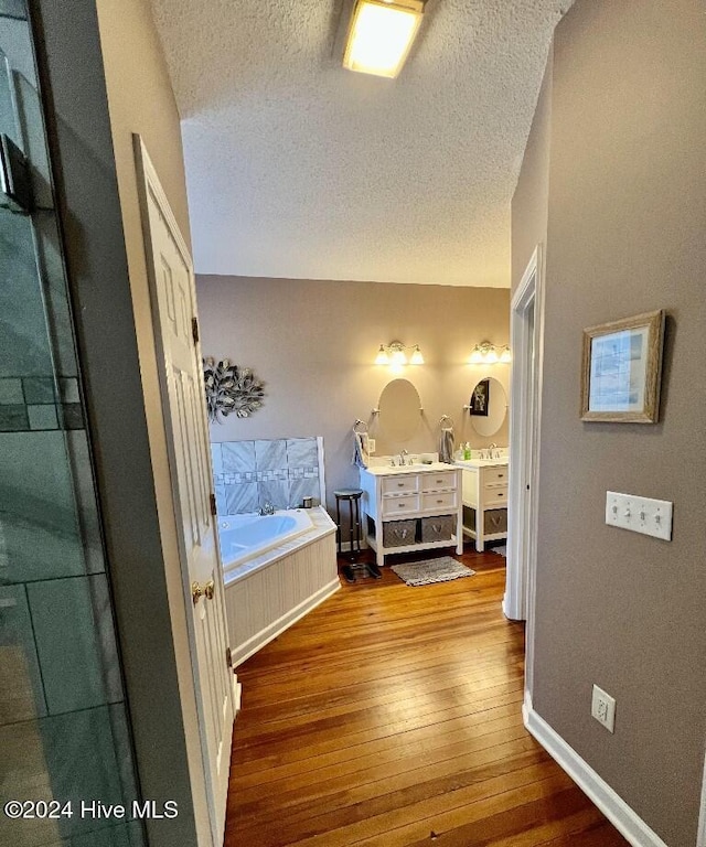 bedroom featuring wood-type flooring and a textured ceiling