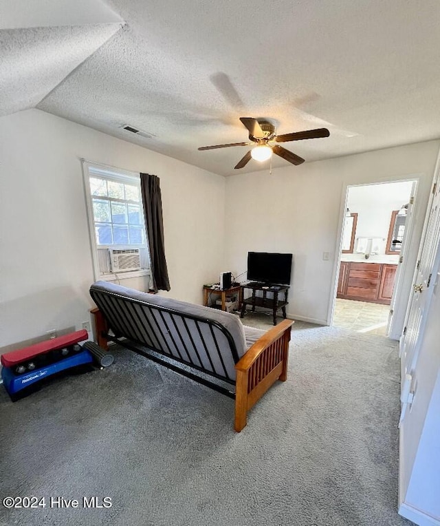 bedroom with a textured ceiling, light colored carpet, vaulted ceiling, ceiling fan, and cooling unit