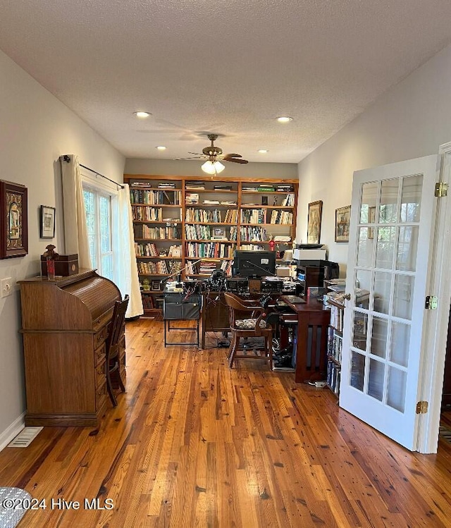 office space featuring ceiling fan, a textured ceiling, and hardwood / wood-style flooring