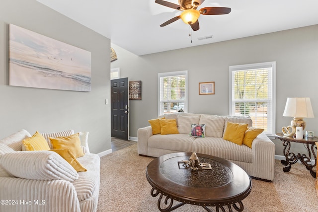 living room featuring light carpet and ceiling fan