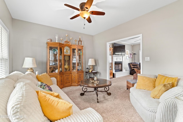 carpeted living room featuring ceiling fan