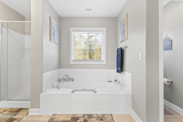 bathroom featuring tile patterned flooring and separate shower and tub