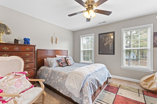 bedroom featuring carpet, multiple windows, and ceiling fan