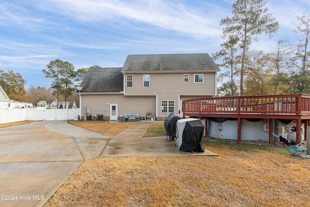 rear view of property featuring a deck