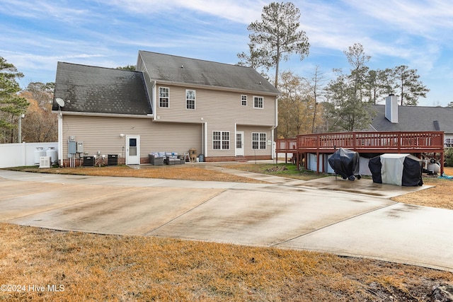 back of house with a deck and central air condition unit