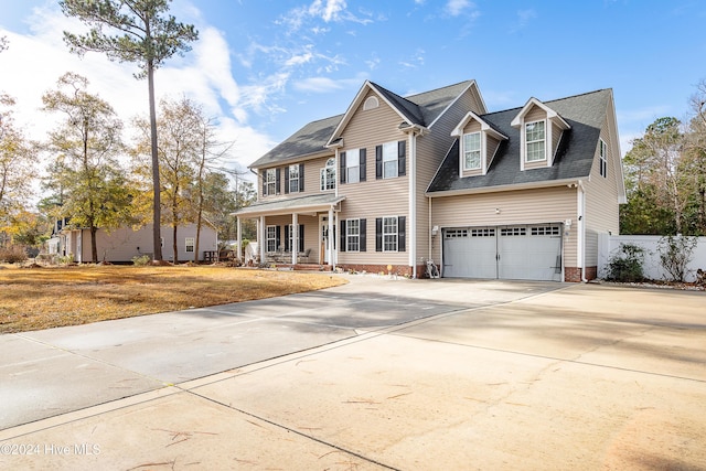 view of front of house with a porch and a garage