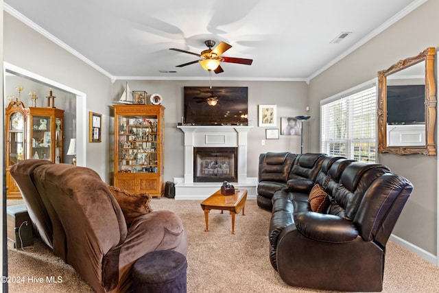 living room featuring ceiling fan, carpet floors, and ornamental molding