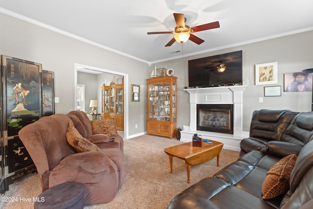 living room featuring carpet flooring, ceiling fan, and crown molding