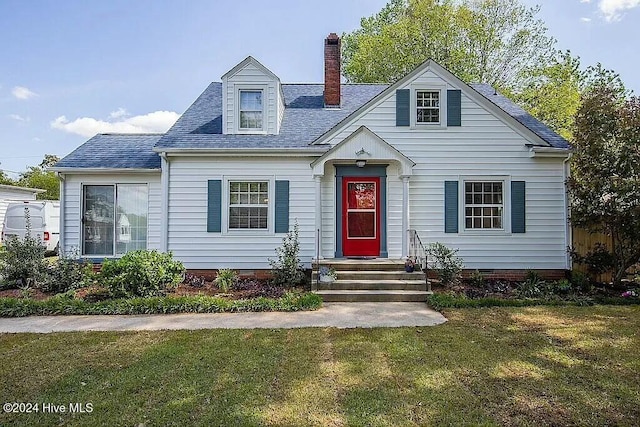 new england style home with a front yard