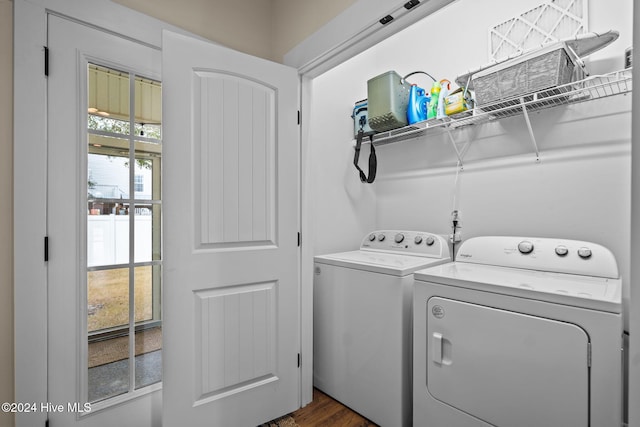 laundry room with dark hardwood / wood-style flooring and washing machine and dryer