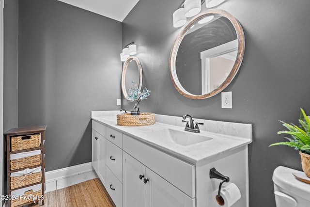 bathroom featuring tile patterned floors, vanity, and toilet