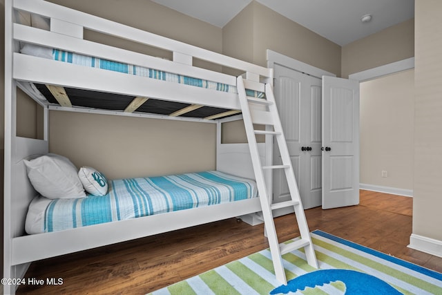 bedroom featuring dark hardwood / wood-style floors and a closet