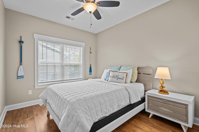 bedroom with wood-type flooring and ceiling fan