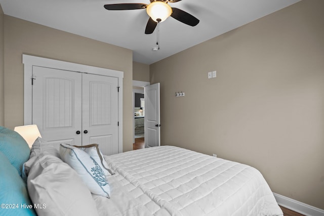 bedroom featuring wood-type flooring, a closet, and ceiling fan