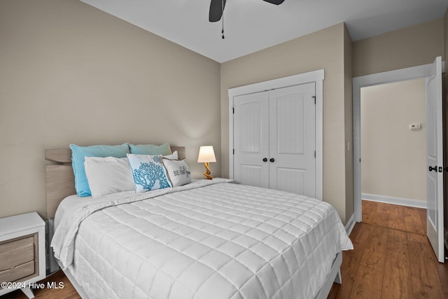 bedroom with ceiling fan, a closet, and hardwood / wood-style flooring