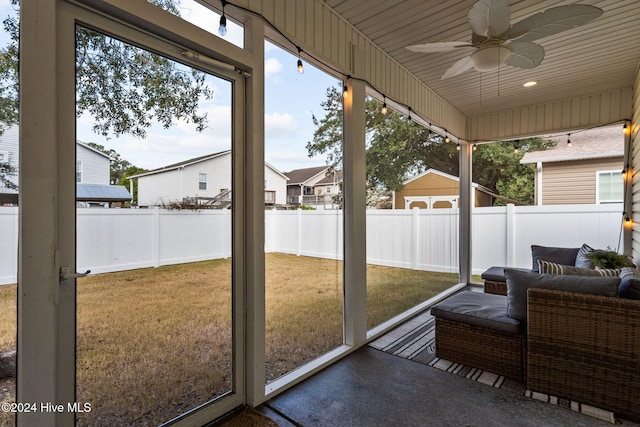 sunroom / solarium featuring ceiling fan