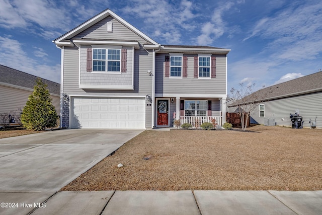 view of front of house with a garage, a porch, and central AC