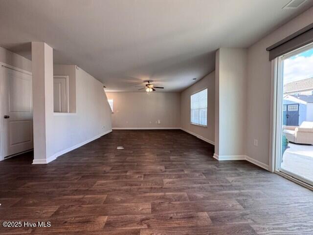 unfurnished living room with dark wood-type flooring and ceiling fan