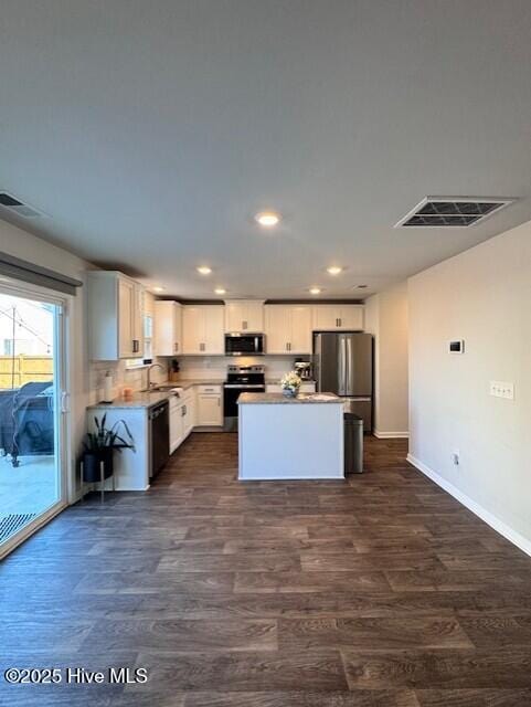 kitchen with white cabinetry, stainless steel appliances, dark hardwood / wood-style floors, and sink