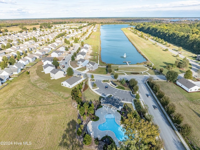 aerial overview of property's location featuring a nearby body of water and a pool area
