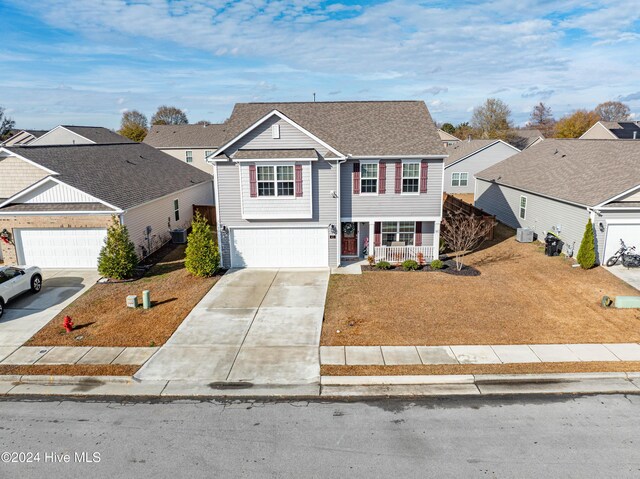 view of front of home with a garage and cooling unit