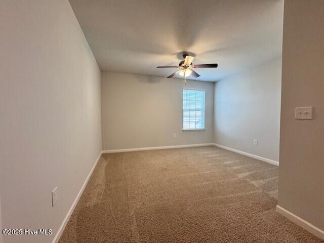 empty room with ceiling fan and carpet flooring