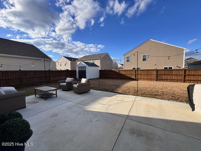 view of patio featuring an outdoor living space and a storage unit