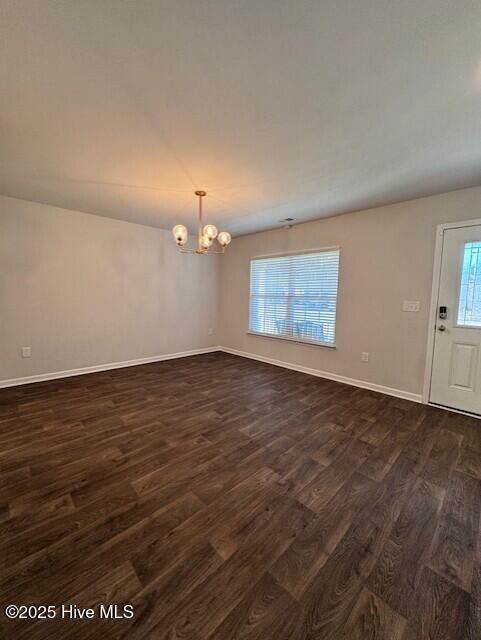 interior space with dark hardwood / wood-style floors and a chandelier