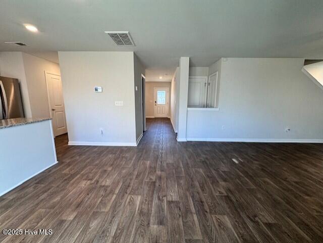 unfurnished living room with dark hardwood / wood-style floors