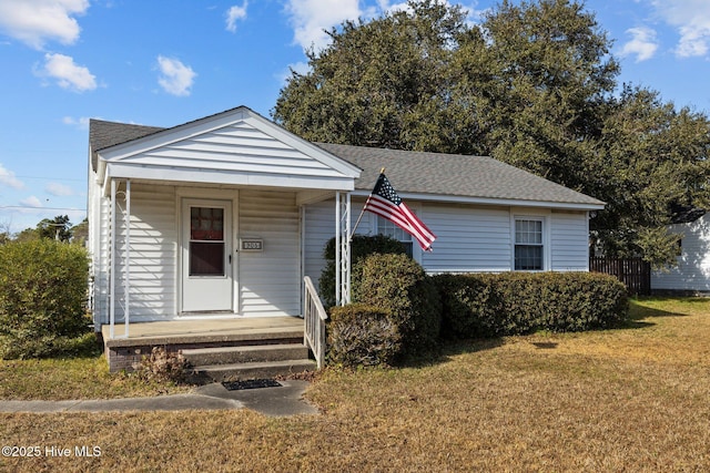 bungalow-style house featuring a front yard