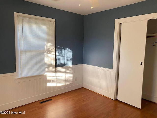 unfurnished bedroom with a closet and hardwood / wood-style floors