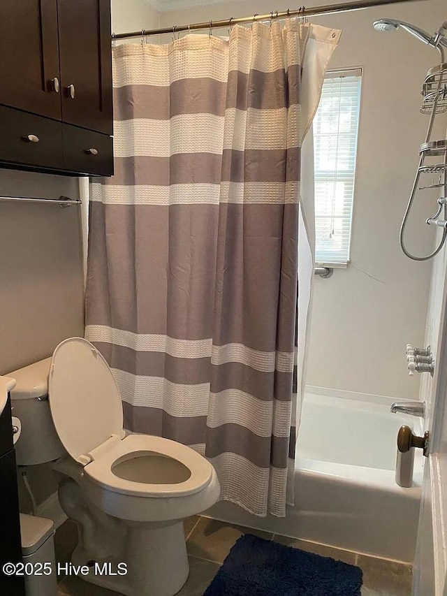 bathroom featuring toilet, tile patterned flooring, and shower / bath combination with curtain