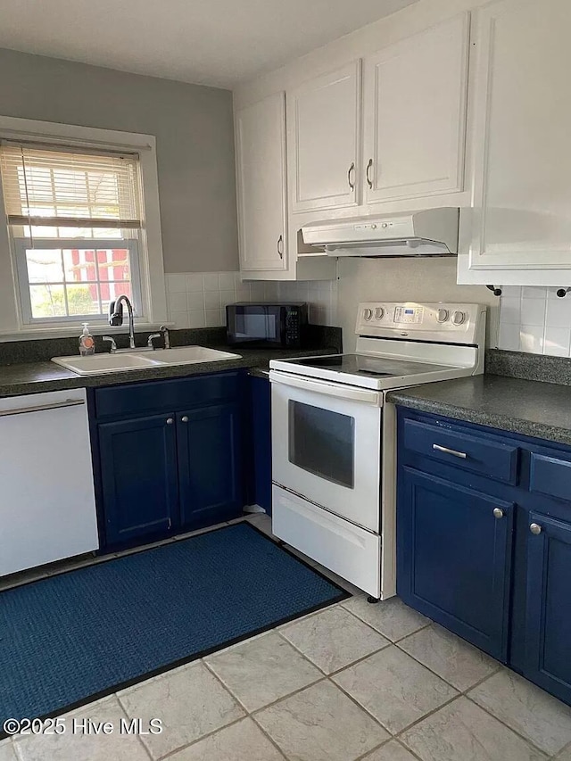 kitchen with tasteful backsplash, white cabinetry, sink, blue cabinetry, and white appliances