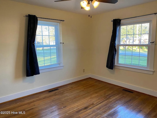 empty room with ceiling fan and wood-type flooring