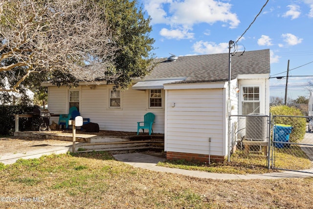 back of house featuring central AC unit