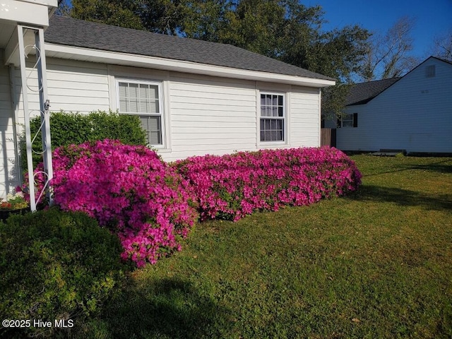 view of side of home featuring a yard