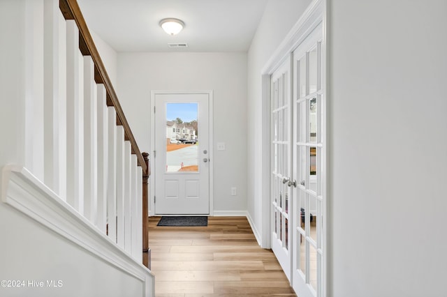 doorway featuring french doors and light wood-type flooring