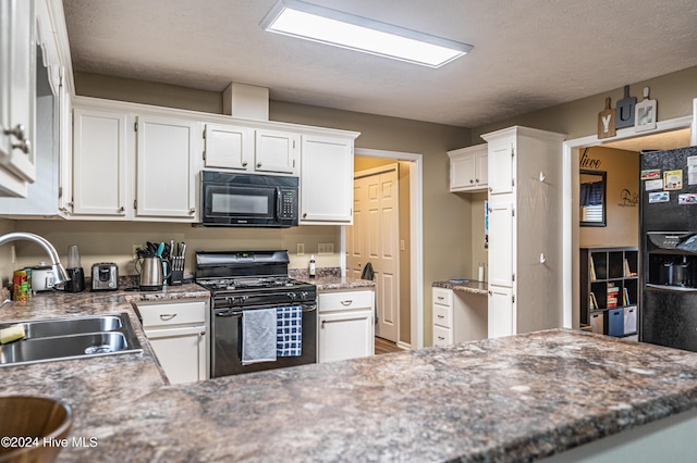 kitchen featuring white cabinets, a textured ceiling, sink, and black appliances