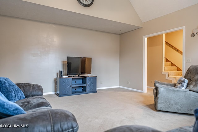 carpeted living room featuring vaulted ceiling