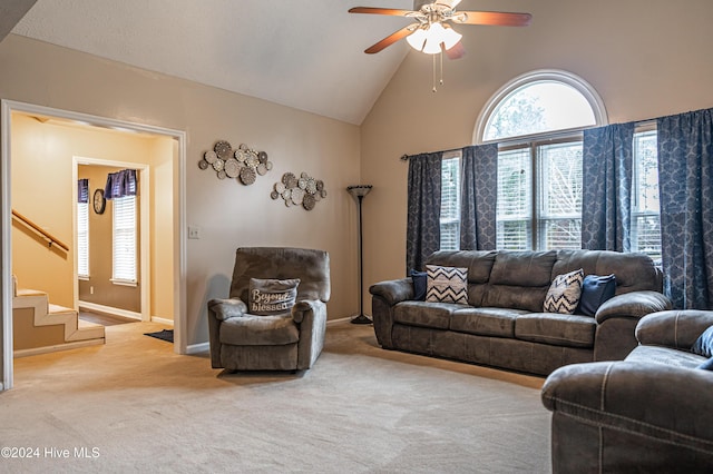 carpeted living room featuring ceiling fan and high vaulted ceiling