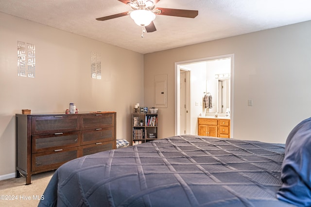 carpeted bedroom with ceiling fan, a textured ceiling, electric panel, and ensuite bath