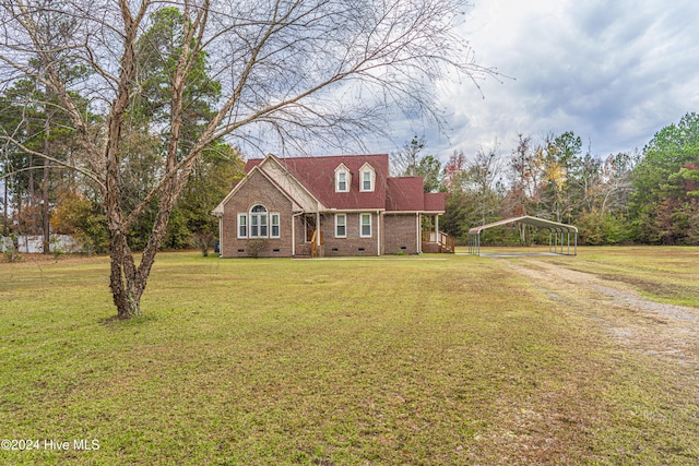 cape cod home featuring a front lawn and a carport