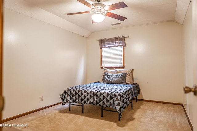 bedroom featuring ceiling fan, lofted ceiling, and light carpet