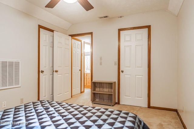 bedroom with a textured ceiling, ceiling fan, a closet, and vaulted ceiling