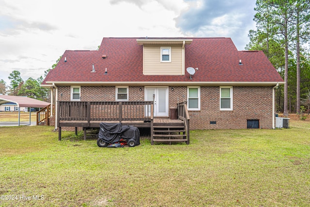 rear view of property with a yard, central AC unit, and a wooden deck