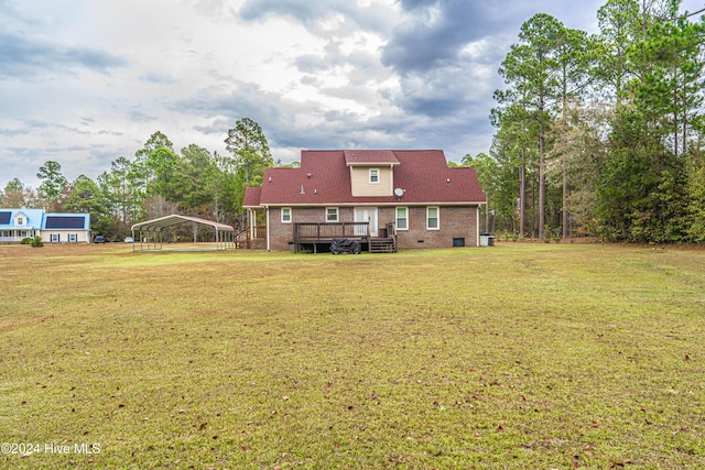 view of yard featuring a wooden deck and a carport