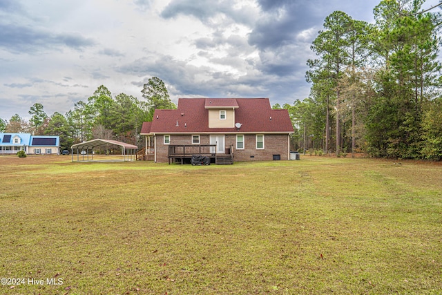 back of property featuring a yard, a deck, and a carport