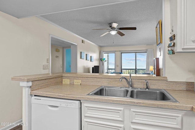 kitchen featuring a textured ceiling, dishwasher, crown molding, and sink