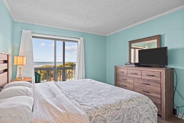 bedroom with access to outside, a textured ceiling, crown molding, and wood finished floors